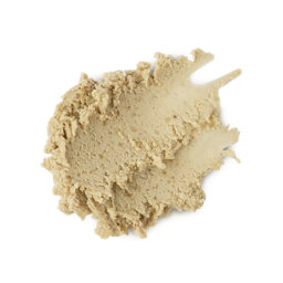 The image shows a neatly smudged swatch of thick, textured, ivory/sand-coloured, paste-like face cleanser product. 