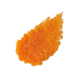 Blood Orange. A neatly smudged swatch of orange granular lip scrub. It has a rough, crystalline texture, resembling coarse sugar, with distinct individual grains visible.