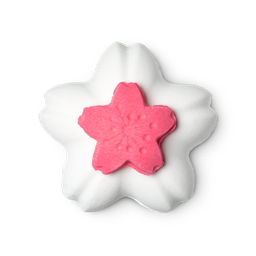 Blooming Beautiful. A triple-sectioned bath bomb in the shape of a 5-pointed Cherry Blossom flower. The product consists of a large white flower base, with a removable pink flower lid, which houses bath salts.