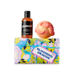 Blooming Dragon Gift. A floral-designed gift box wrapped in blue string. A themed shower gel and bath bomb sit on top. 
