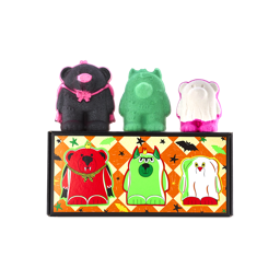 Boo Bears gift. Three monster bear bath bombs sit atop an orange chequered box featuring illustrations of themselves. Left to right: a black vampire bear, a green three-eyed monster bear, and a white ghost bear with bright pink feet.