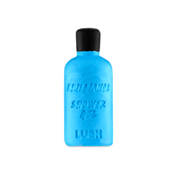 Brilliance. A bright blue solid shower gel bar shaped like a bottle, embossed with the words 'BRILLIANCE SHOWER GEL' and 'LUSH'. It features a moulded black top resembling a cap.