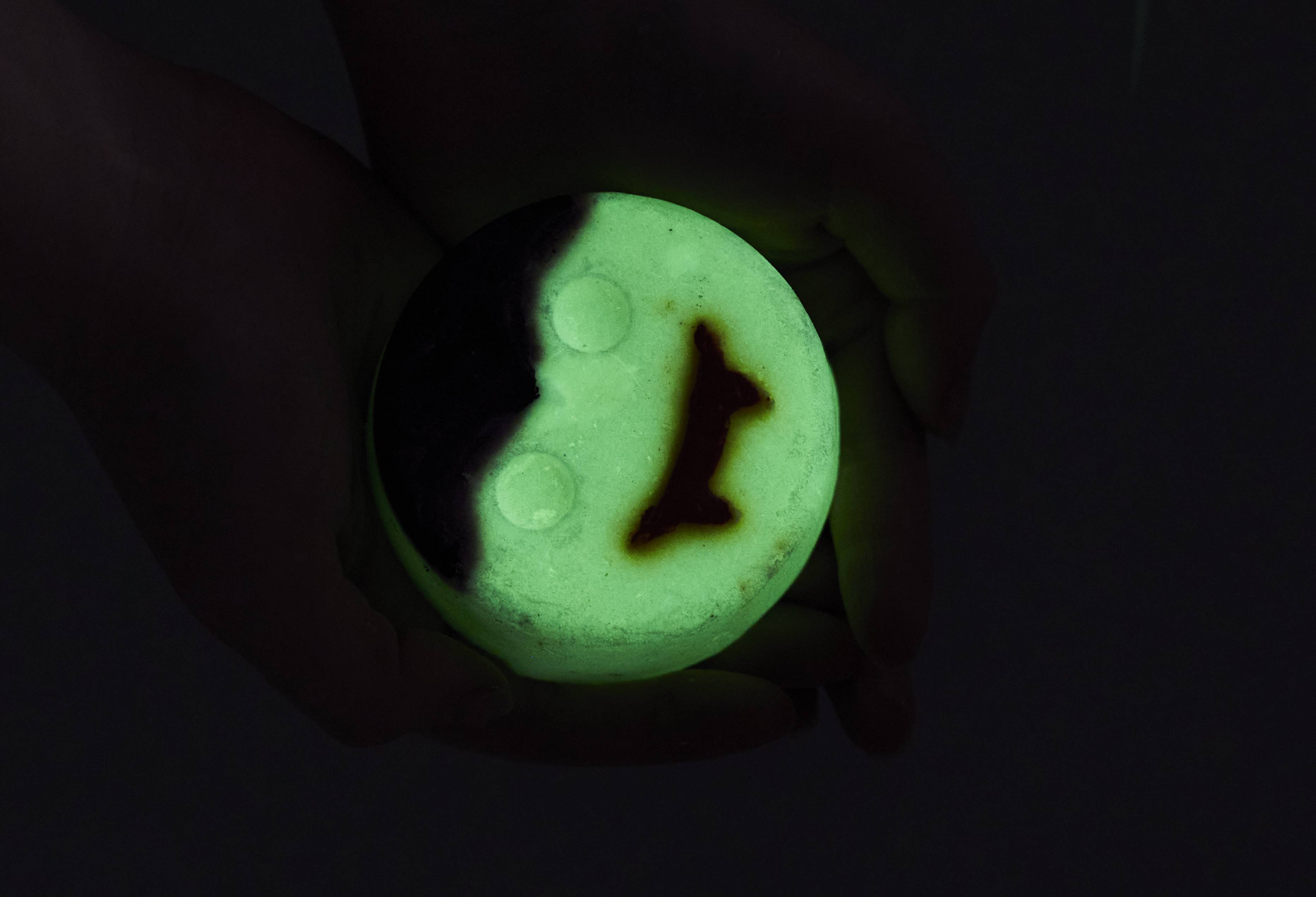Image shows the bubble bar surrounded by blackness as the white face glows, almost neon, brightly in the dark.