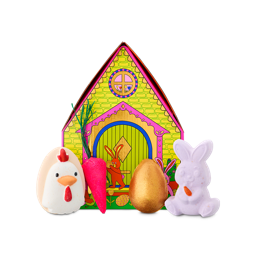 Bunny Cottage. A house-shaped tin decorated with a bunny and yellow bricks. Arranged in front are four Easter-themed bath products, including three bath bombs and a bubble bar. 