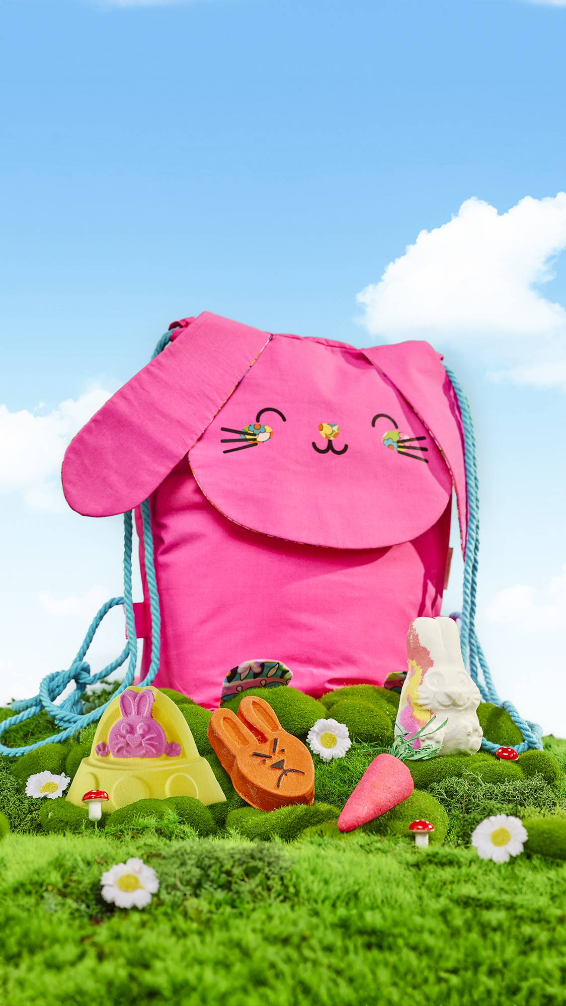 Flower Bunny. A gift consisting of a bright pink, rabbit-shaped, reusable backpack with four Easter-themed bath products laid in front.