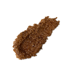 Buzz. A neatly smeared swatch of thick, textured, deep caramel-coloured lip scrub with visible sugar granules.