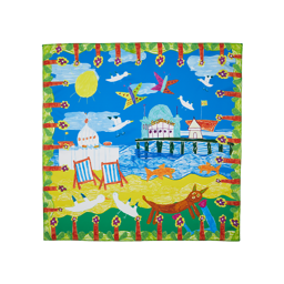 By The Seaside. A square knot wrap with a drawn, floral border depicting a sunny beach day complete with Brighton Pier, blue skies, deck chairs and seagulls. 