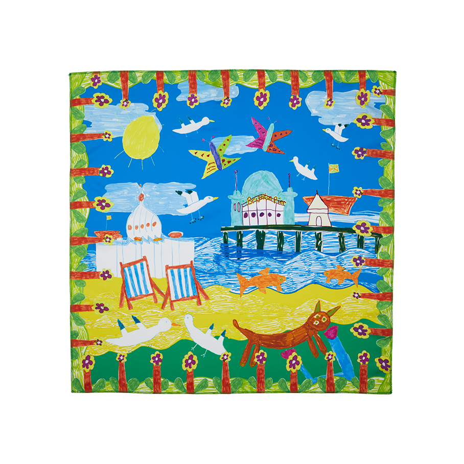 By The Seaside. A square knot wrap with a drawn, floral border depicting a sunny beach day complete with Brighton Pier, blue skies, deck chairs and seagulls. 