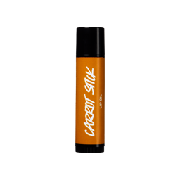 Carrot Stick. The lip oil's packaging is shown from the side with an orange label and black top and bottom. 