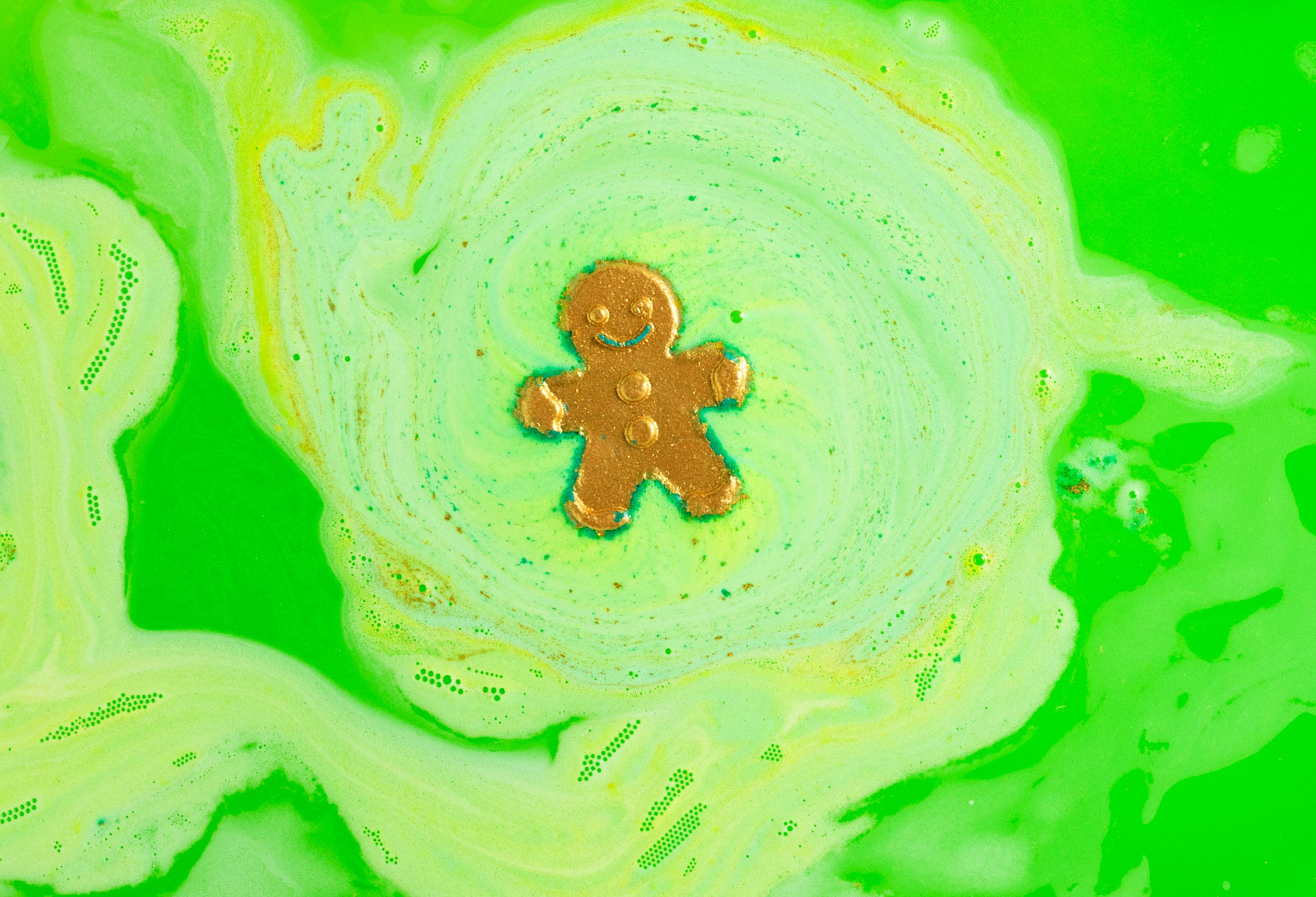 Image shows the Catch Me If You Can bath bomb dissolving, releasing yellow and green neon swirls.