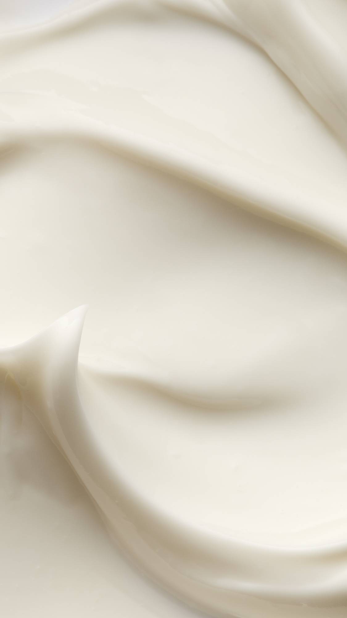 A super close-up of the Celestial self-preserving moisturiser focusing on the almost velvety, fabric-like waves of creamy, satin, lotion.