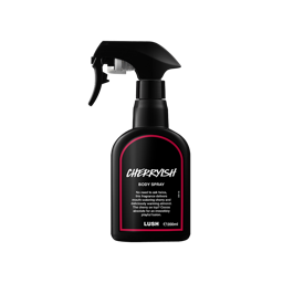 A recycled black plastic LUSH body spray bottle with a trigger nozzle stands upright with a red rimmed label with white text that reads "Cherrish Body Spray".
