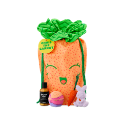 Chris The Carrot. A gift comprised of an orange drawstring bag designed to look like a smiling carrot with a green leafy top. It is displayed alongside four bath products, including two bath bombs, a bubble bar and a bottle of shower gel.