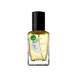 A clear glass bottle of Lush "Christmas Eve" perfume containing yellow fragrance, featuring a black cap and a crescent moon graphic label with a green "Lush Club" sticker