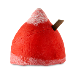 Christmas Kisses. A pointed, dome-shaped bubble bar in a deep red colour. There is a frosting of white on the top and bottom and a small cinnamon stick pokes out the product's side. 