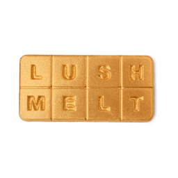 Cinnamum. A rectangular slab of wax for burners or baths. It is a shimmering, glittering gold and embossed into eight, equal segments. In each segment is a letter, spelling out the words "LUSH MELT"