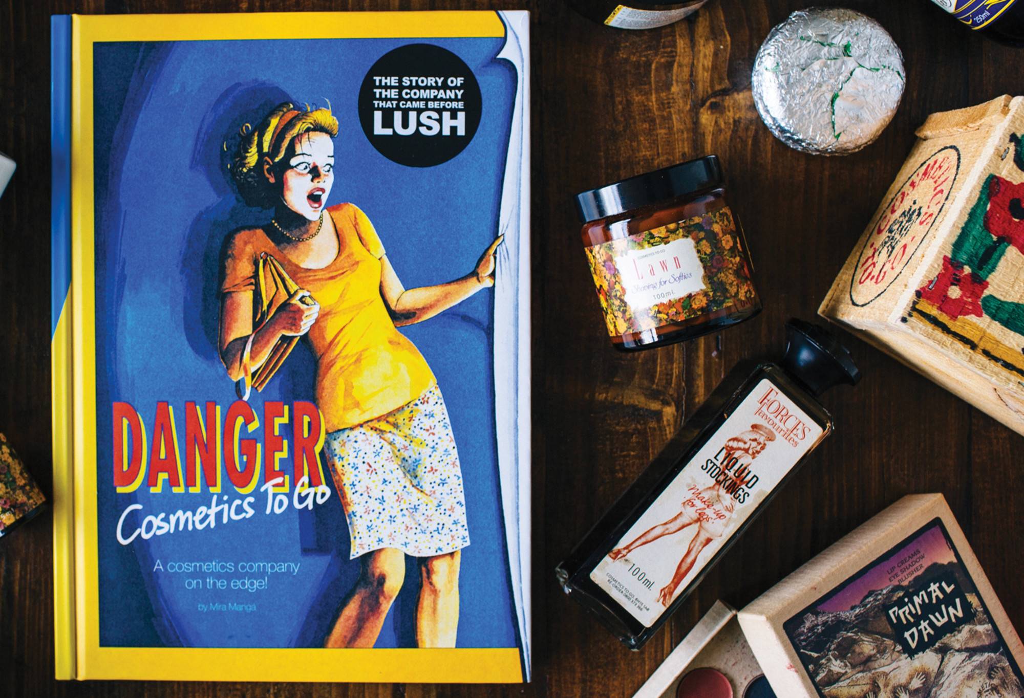 The book presented next to older style lush business products.