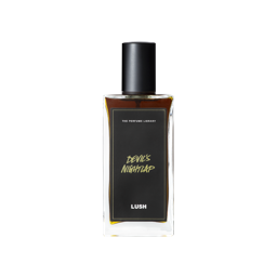 A glass perfume bottle filled with dark mahogany liquid. A black label reads 'The Perfume Library' and 'Devil's Nightcap'.