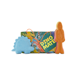 Dino Mate. A short, rectangular gift box wrapped in paper designed with different types and colours of dinosaurs, tied with an orange string and gift tag. Two bath bombs are sitting by the sides of the box. 