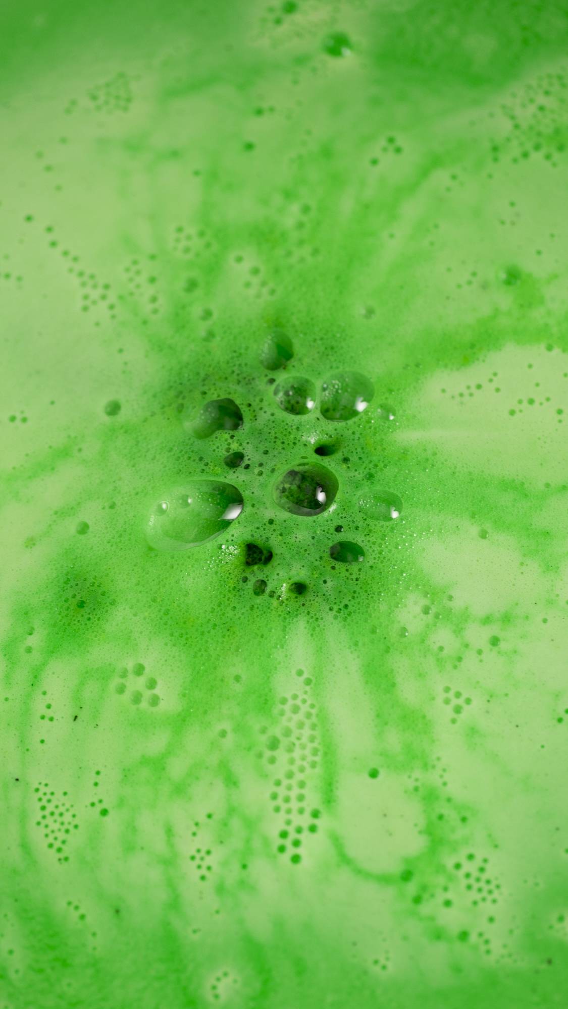 The Dinosaur in a Crisis bath bomb has almost fully dissolved leaving a velvety green sea of thick foamy bubbles. 