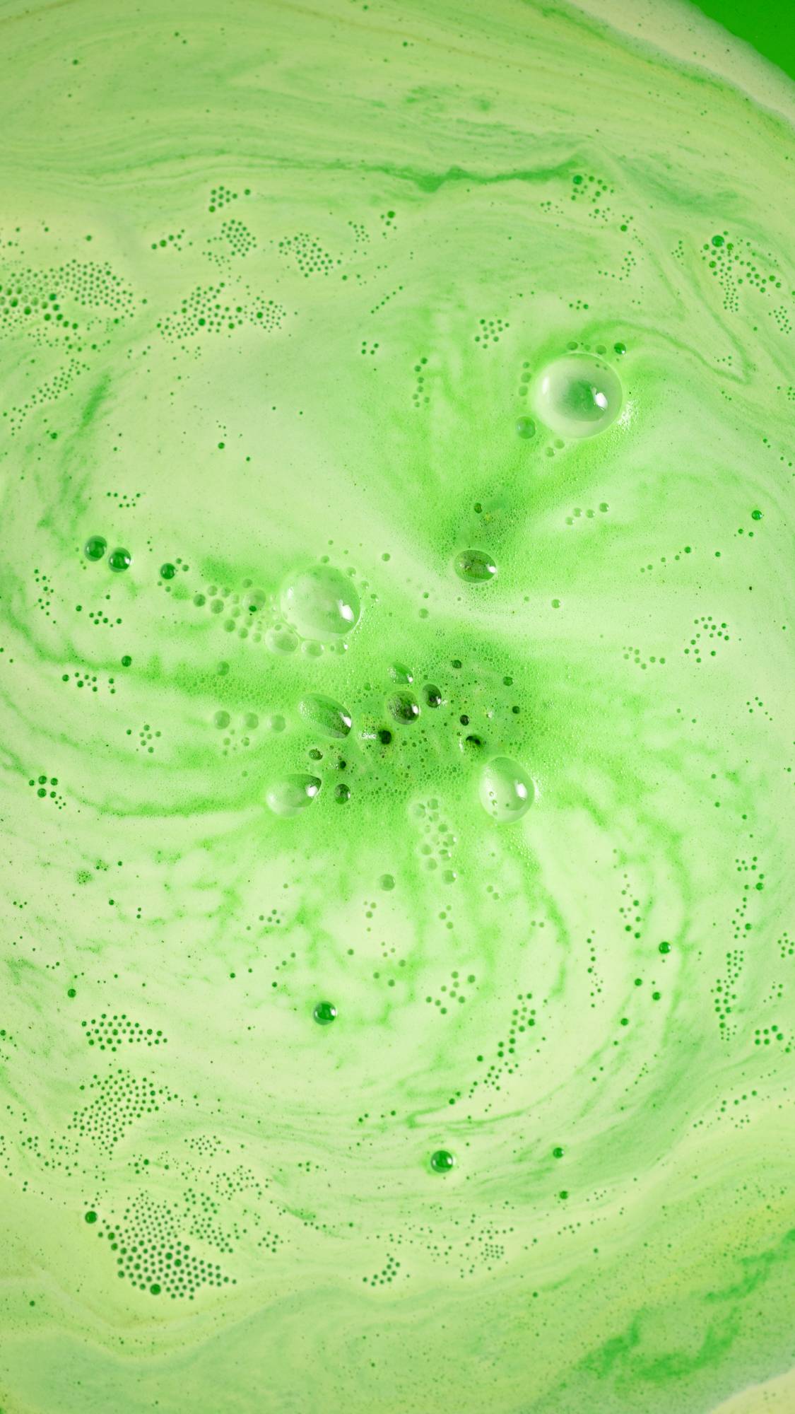 The Dinosaur in a Crisis bath bomb has almost fully dissolved leaving a velvety green sea of thick foamy bubbles. 
