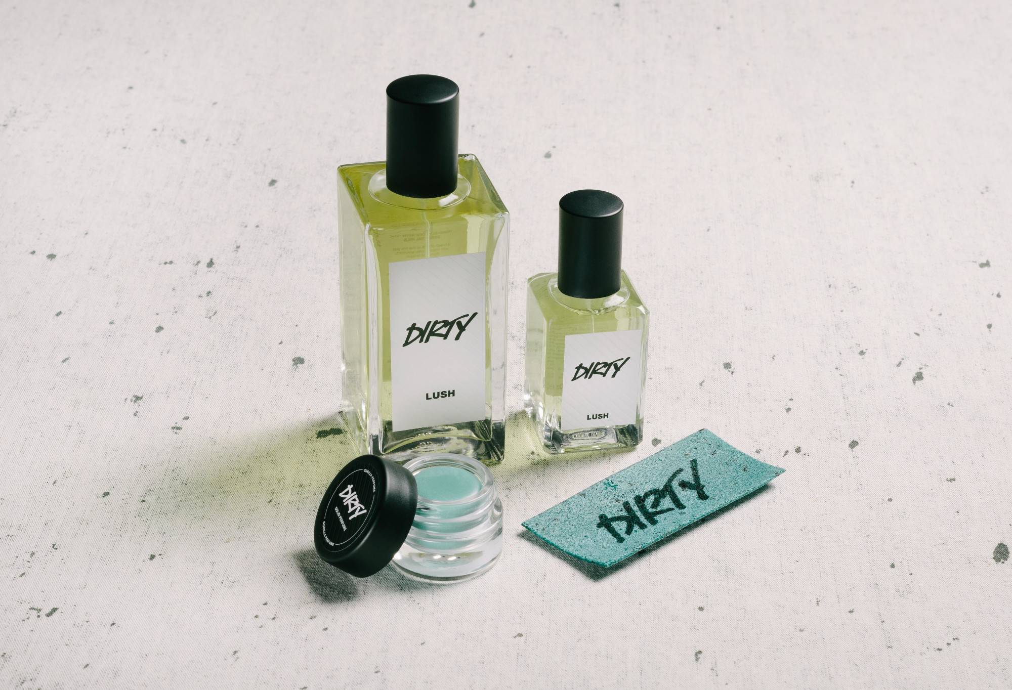 The whole Dirty fragrance collection (bar body spray) is displayed on a white surface, flecked with grey.