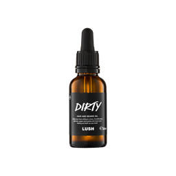 A small, amber glass bottle of "Dirty" hair and beard oil by Lush. The bottle features a black label with white text and a black pipette dropper lid, containing 30ml of product.