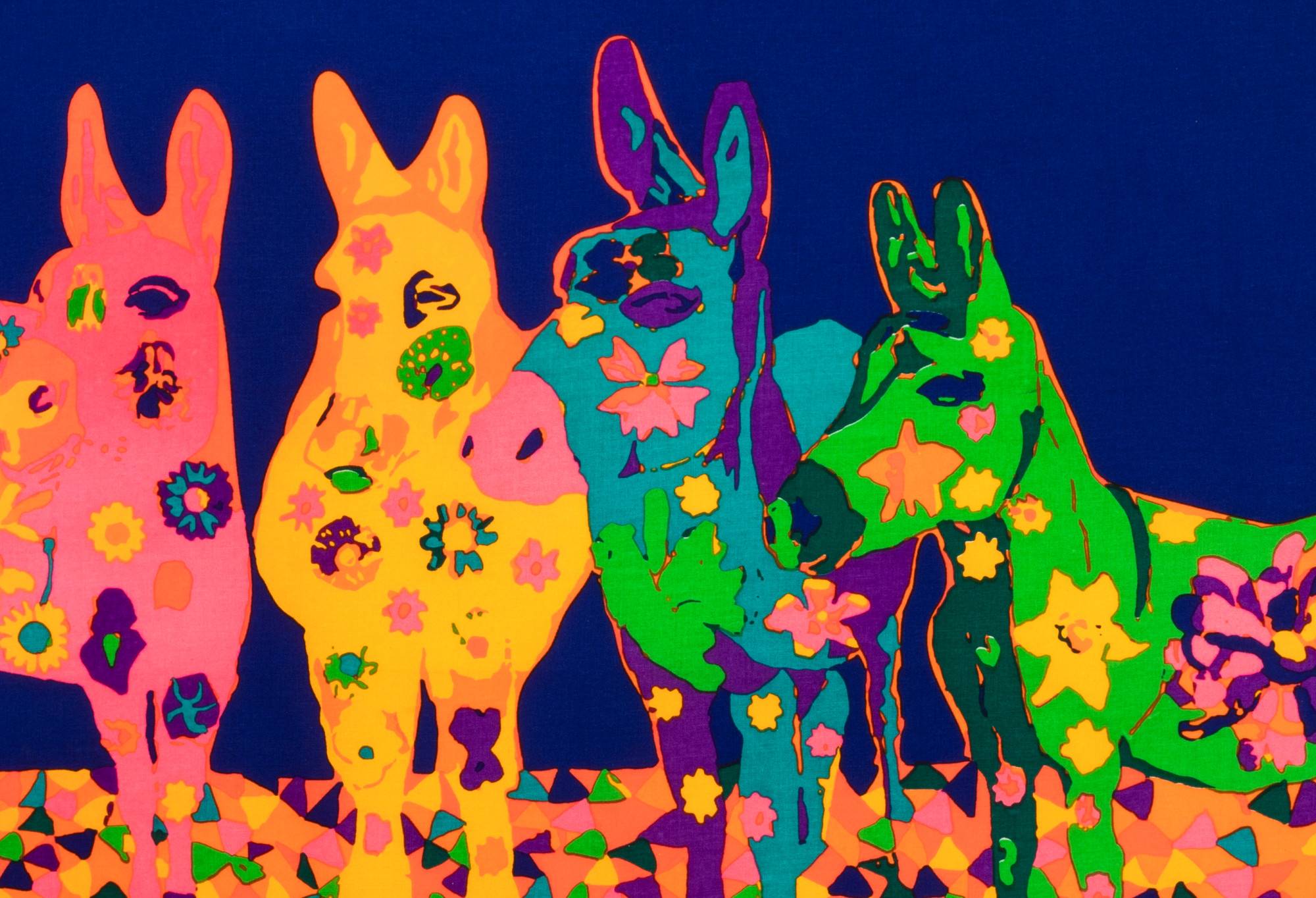 A close up of the Knot Wrap, focusing on the pink, yellow, blue and green donkeys.