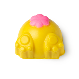 Down The Rabbit Hole, a yellow body scrub in the shape of a rabbits behind, with its paws out and a pink puffy tail. 