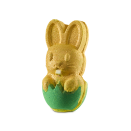 Easter Bunny. A bath bomb shaped like a bunny sitting in an eggshell. The eggshell is a bright green colour and the bunny is a sparkling, gold lustre poking out of the eggshell with its paws over the edge, ears up, and little buck teeth.