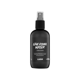 A black spray bottle of Lush Eau Roma Water toner water with a clear plastic cap, featuring white text on a black label