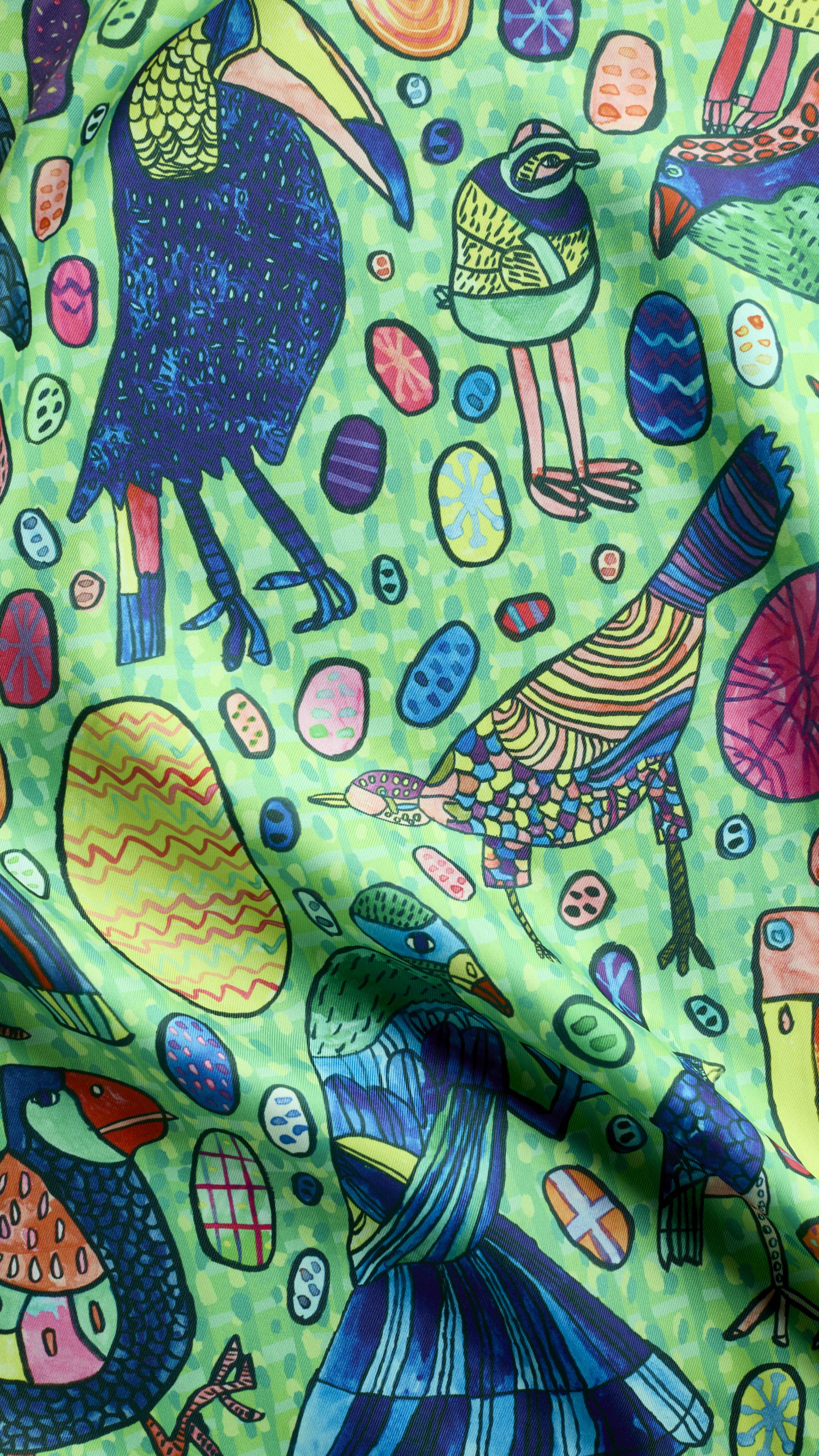 A super close-up of the "Eggs For The Exotic Birds" knot wrap featuring a hand-drawn pattern of exotic birds and decorative eggs. The detailed design includes a blue toucan, a striped bird, and various patterned eggs.
