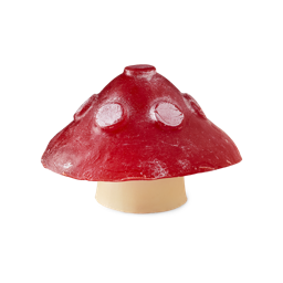 Faerie Realm. A toadstool-shaped soap with a deep red cap featuring raised, pale spots resting on a short, cream-coloured stem.