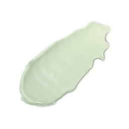 A close-up product swatch of a thick, elongated, textured streak of Feeling Greener primer. The color is a pale, creamy pastel green