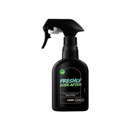 A black product shot of the Freshly Ever After Body Spray bottle, featuring a black trigger sprayer top and a rectangular black and white label with green accents on a black background.