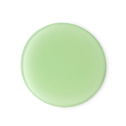 A perfectly round, glossy puddle of vibrant, pale lime green liquid is centered on a light grey background. This is a swatch of the Freshly Ever After shower gel.