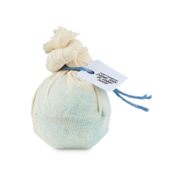 Gentle Mugwort Cataplasm. A blue, spherical bath bomb wrapped in muslin fabric, tied with a knot and blue string and product tag which reads "Don't unwrap, dunk this in your bath"