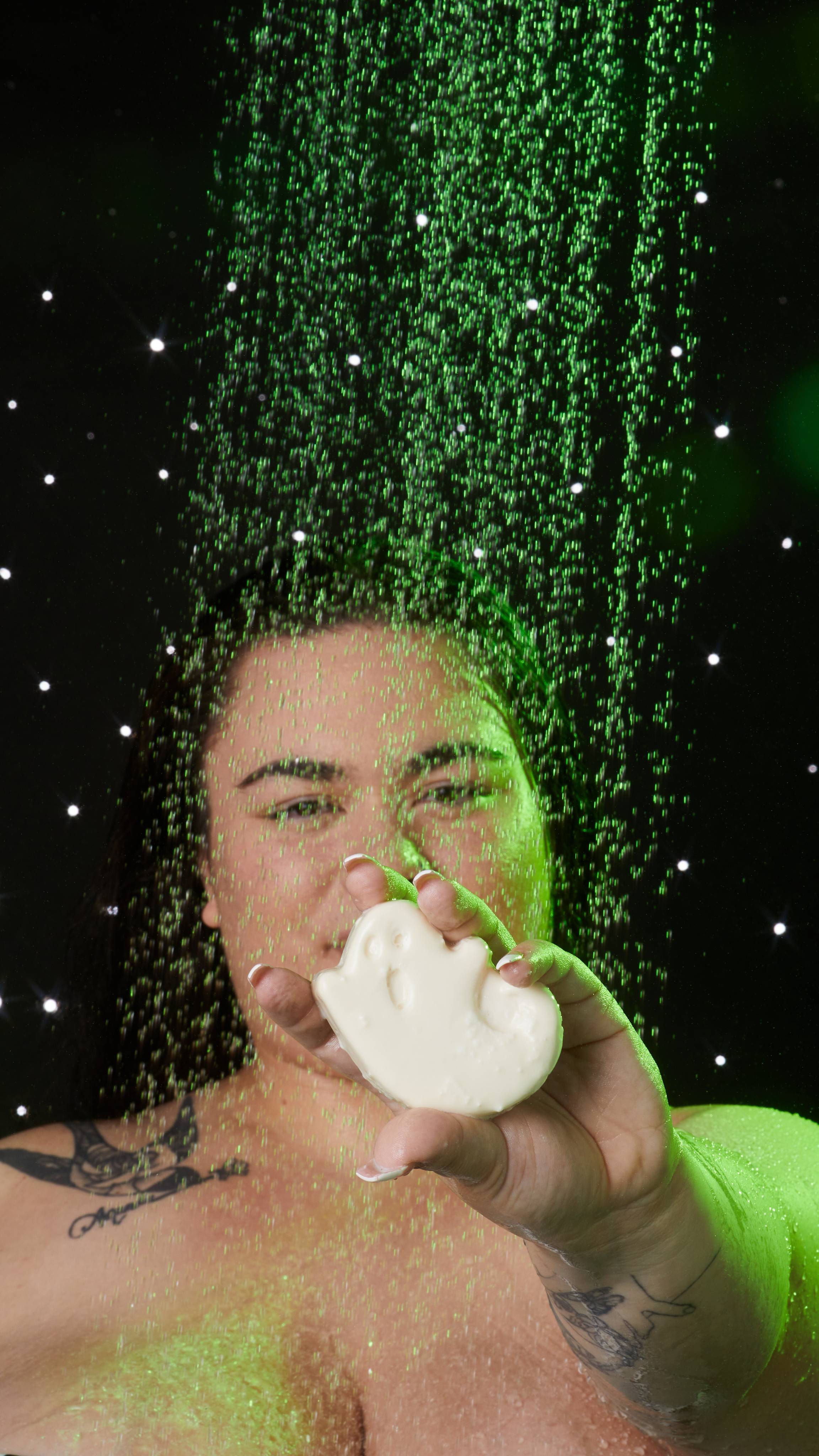 Model is stood facing the camera holding the soap in an outstretched arm focusing on the soapy ghoul.