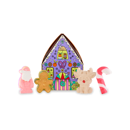 Gingerbread House. A cardboard gift box shaped like a purple house with an array of Christmas-themed illustrations. Four Lush Christmas-themed products sit in front of the gift box. 