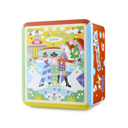 Glasgow Tin. A cuboid tin with a colourful illustration on its front. It features three people and a man on horseback, with flowers and city landmarks, and the text 'LUSH' and 'Glasgow', appearing vibrant and cartoonish.
