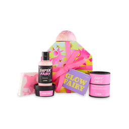 Glow Fairy. An octagonal-shaped gift box with a vibrant pink and yellow starred design, tied with a pink ribbon and gift tag. Five Snow Fairy-themed products sit around the box. 