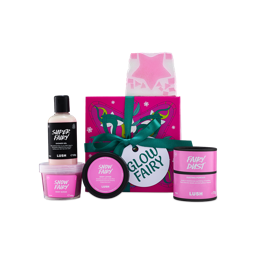 A Lush Glow Fairy gift box tied with a green ribbon, displayed with Super Fairy shower gel, Snow Fairy body scrub, Snow Fairy body lotion, Fairy Dust dusting powder, and a star-patterned soap slice
