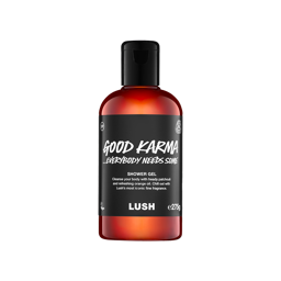 A clear bottle filled with translucent, bright orange Lush Good Karma... Everybody Needs Some shower gel, topped with a black cap and featuring a black label
