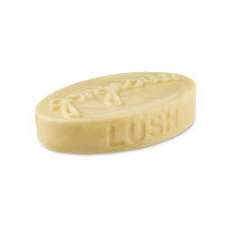 Gorgeous. A creamy, solid massage bar. The product is a thick, oval-shaped slab with "LUSH" embossed on one side and the word "Gorgeous" on top.