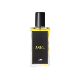A glass perfume bottle filled with canary yellow liquid. A black label reads 'The Perfume Library' and 'Grass'.
