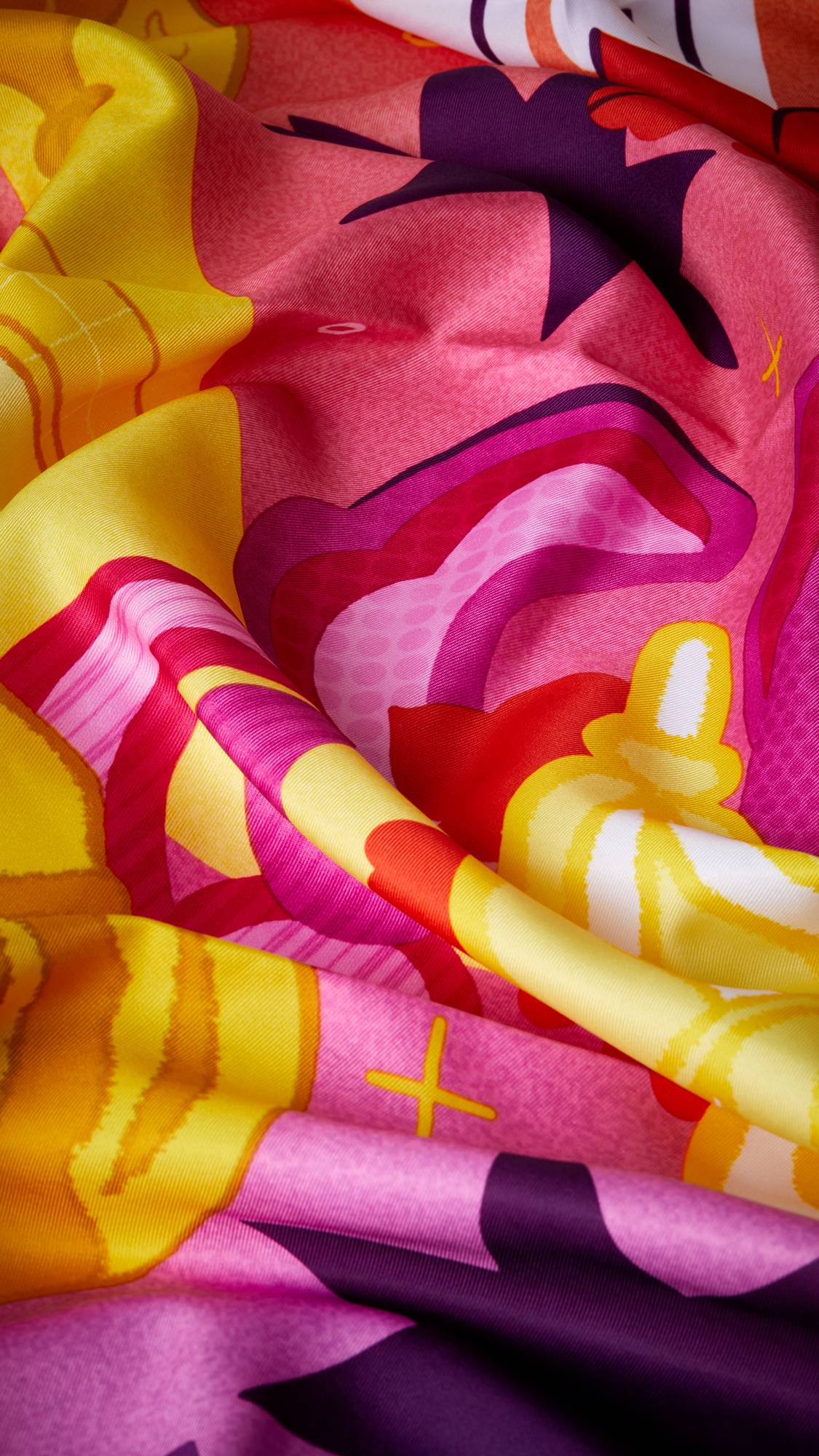 A super close-up image of the Guiding Lights knot wrap focusing on the ruffles of fabric and pattern.