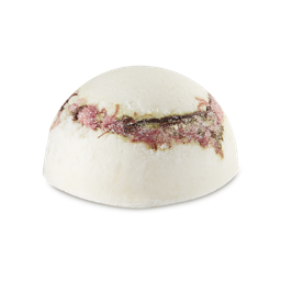 Hanami. A half-sphere-shaped solid body scrub. It is a light cream/white colour with visible sugar granules. There is a layer of pink petals running around the centre of the product. 