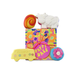 Happy Daze. A square gift box with a colourful neon flower design, tied with an orange string and a pink gift tag. Four bath products sit on top of and in front of the gift box. 