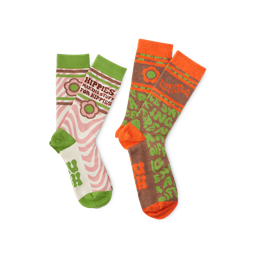 Happy Hippy. Two pairs of colourful socks. One has a green toe, heel and trim with pink swirls and text that says "Hippies making stuff for hippies" and the other has an orange toe, heel and trim with green text that says "Making a Difference"