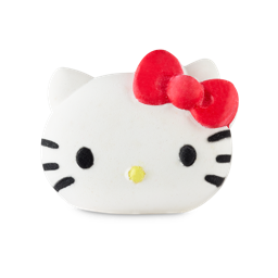 Hello Kitty. A playful bath bomb shaped like a simple cat's face. It is white in an oval shape. The face is complete with small black eyes, whiskers, a small yellow nose and a large red bow over one ear. 